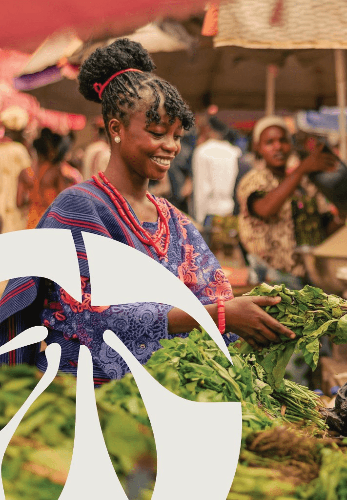 Mosolande brand photo of a customer choosing fresh greens at a market stall